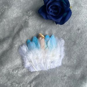 Beautiful handmade white blue and gold feathered hairpiece